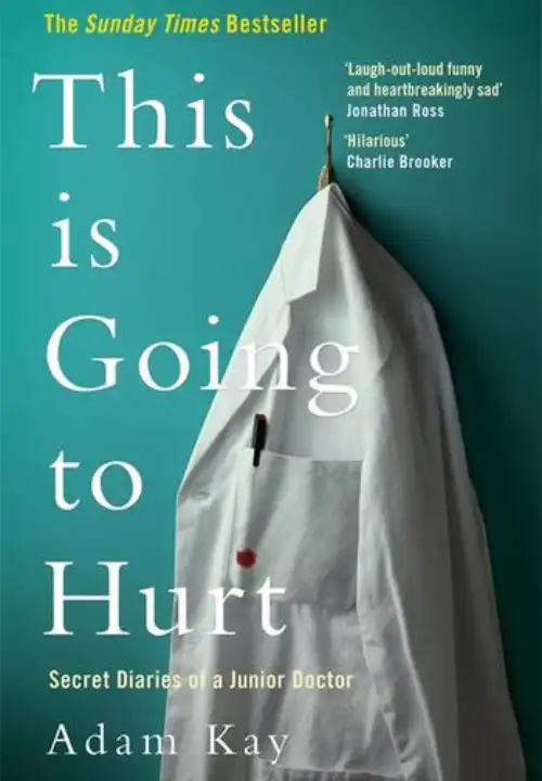 Book Cover of This is Going to Hurt. A white doctors lab coat hangs on a gold coat hook on a turquoise wall. The lab coat has a pocket which has a pen poking over the top and a red splotch bleeding though near the bottom of the pen. We don't know whether the red stain is ink or blood.