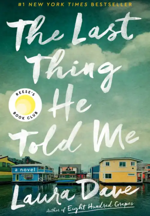 Book Cover of The Last Thing He Told Me. Three properties moored over a body of water covers the lower third of the cover. The top of the cover is a blue sky with clouds.